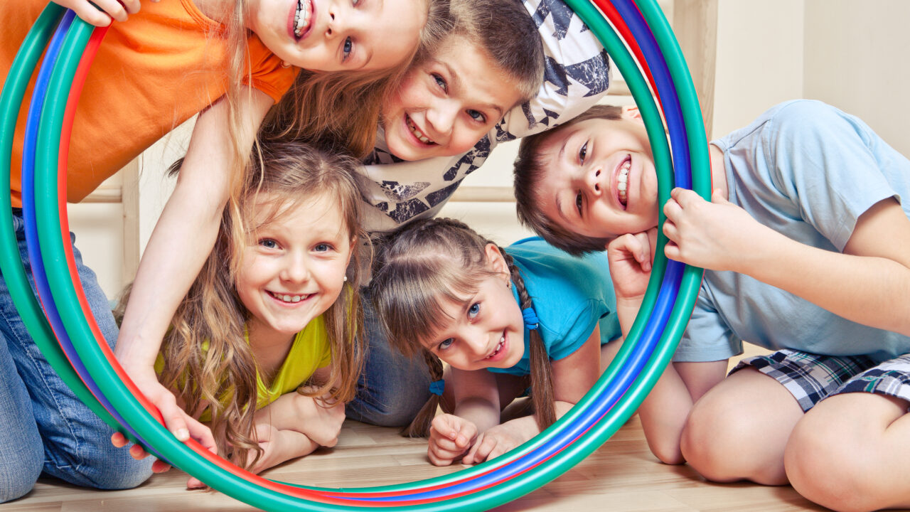 Five,Cheerful,Kids,Looking,Through,Hula,Hoops