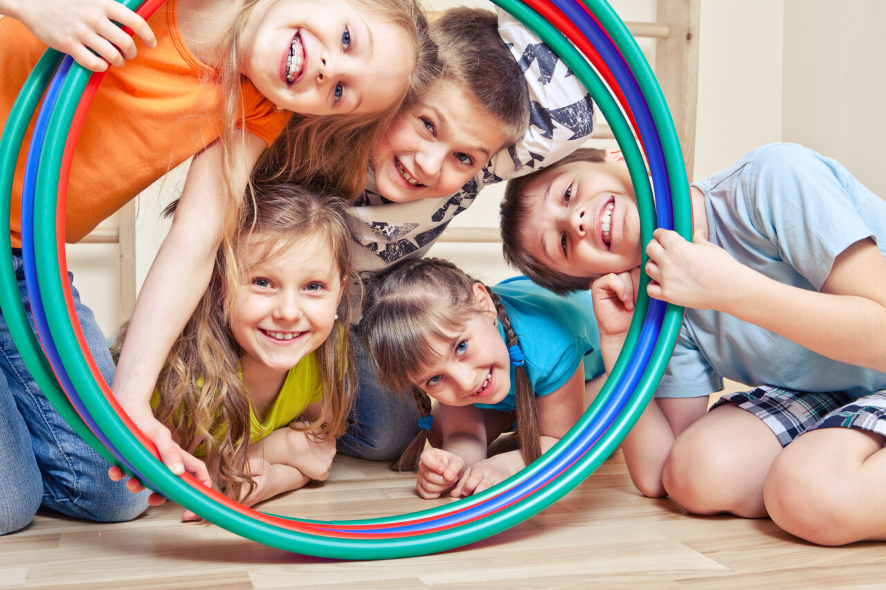 Five,Cheerful,Kids,Looking,Through,Hula,Hoops